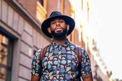 Stylish Black man walking on the city street