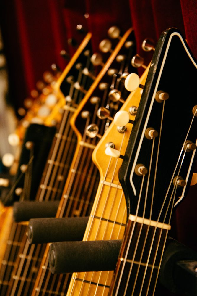 Row of guitar heads with tuning pegs