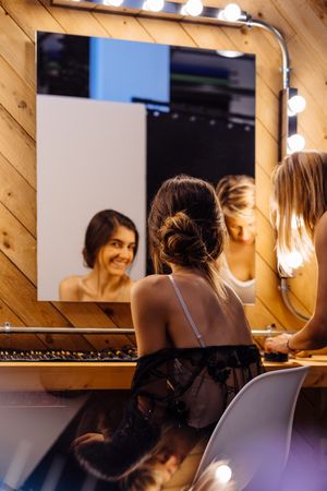 Makeup artist doing makeup for young female artist