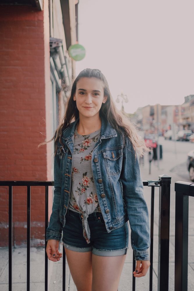 Smiling modern woman standing on street