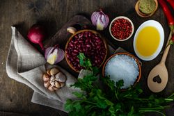 Top view of wooden table with all the ingredients for vegetarian chili 