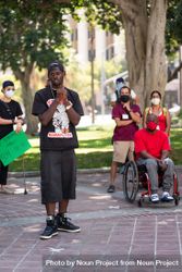 Los Angeles, CA, USA — June 16th, 2020: male speaker talks to group of people at protest rally 4d8Zr4