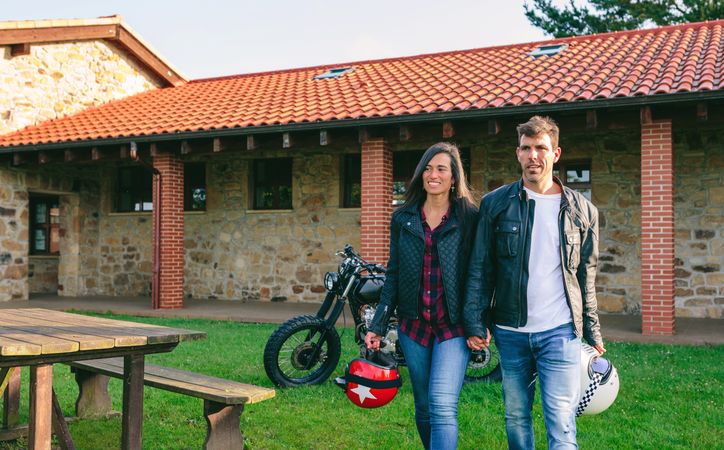 Couple walking holding hands and custom motorcycle