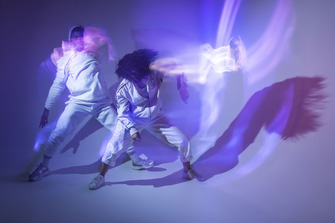 Anonymous dancers under violet illumination