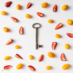 Pattern made of kumquats, strawberries with key