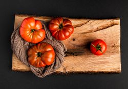 Tomatoes and napkin on wooden board