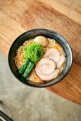 Delicious Asian soup with noodles and rolled chicken served in bowl