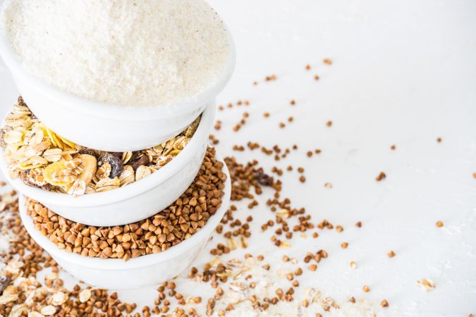 Three bowls full of different super food grains piled on table