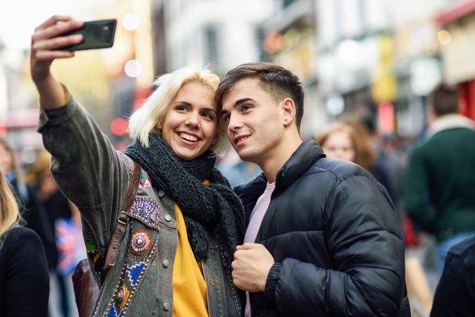 Female taking selfie with her boyfriend in UK street