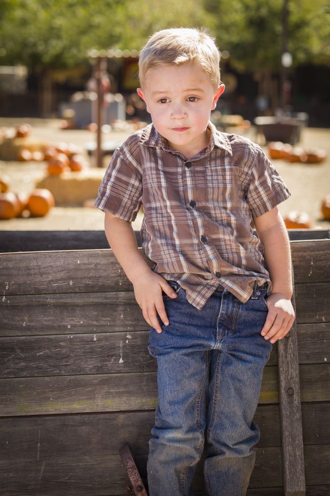 Little Boy With Hands in His Pockets at Pumpkin Patch.