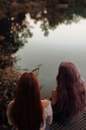 Women with long hair on lake shore