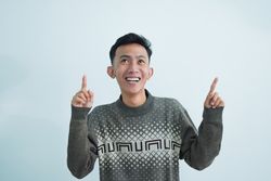 Asian man showing pointing gesture