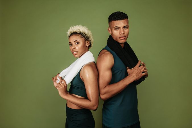 Black couple posing post workout with towels