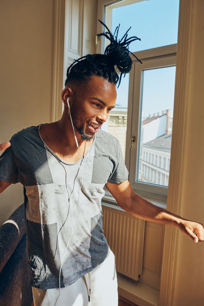 Cheerful Black male listening to music