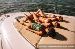 Relaxed female friends sunbathing on yacht 4jBQx4