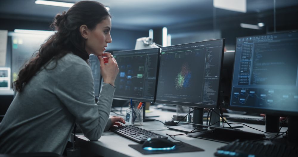 Portrait of a Thoughtful Young Engineer Working on Computer in a Technological Office Environment.