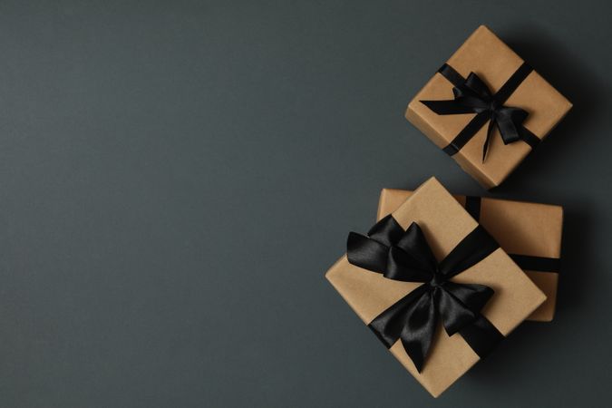 Craft gift boxes with bow on gray background