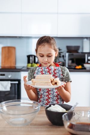 Girl making Italian tiramisu dessert
