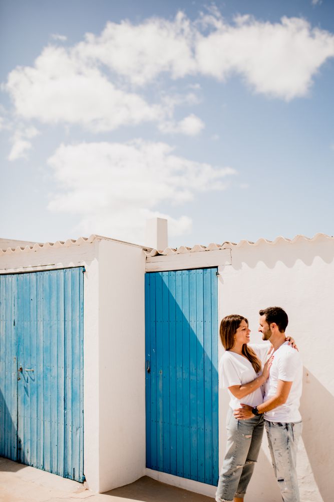 Loving couple cuddling near beach house