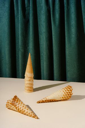 Waffle cones in front of green curtain background