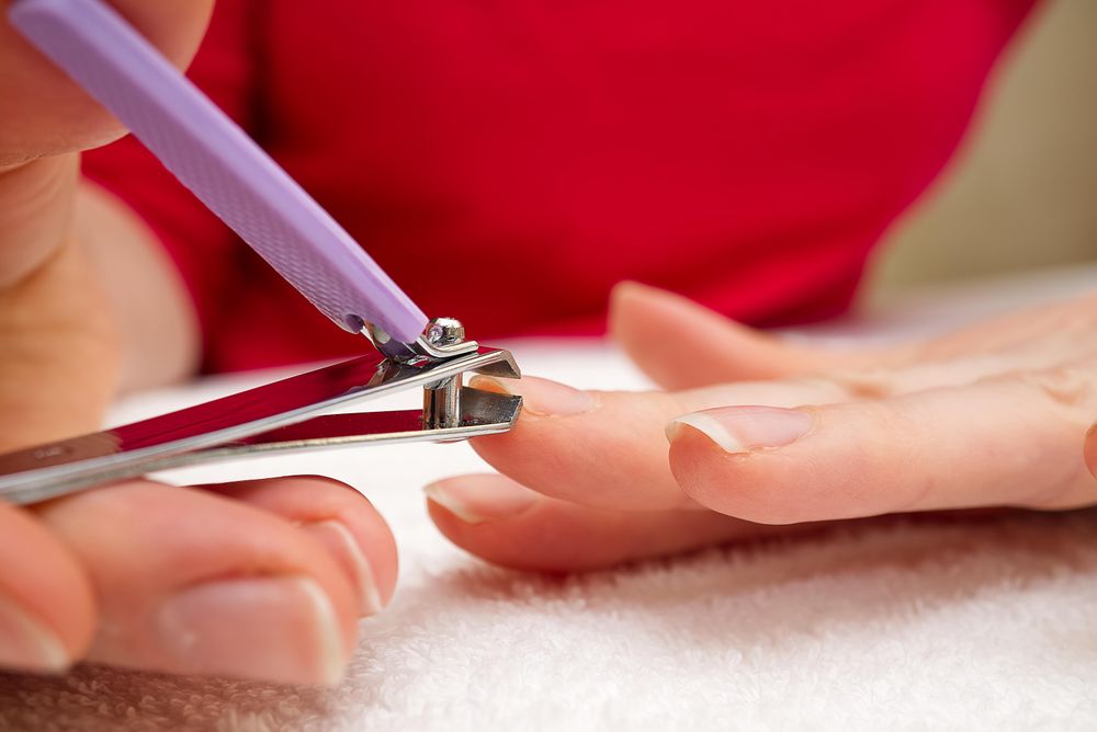 Woman holding silver nail cutter