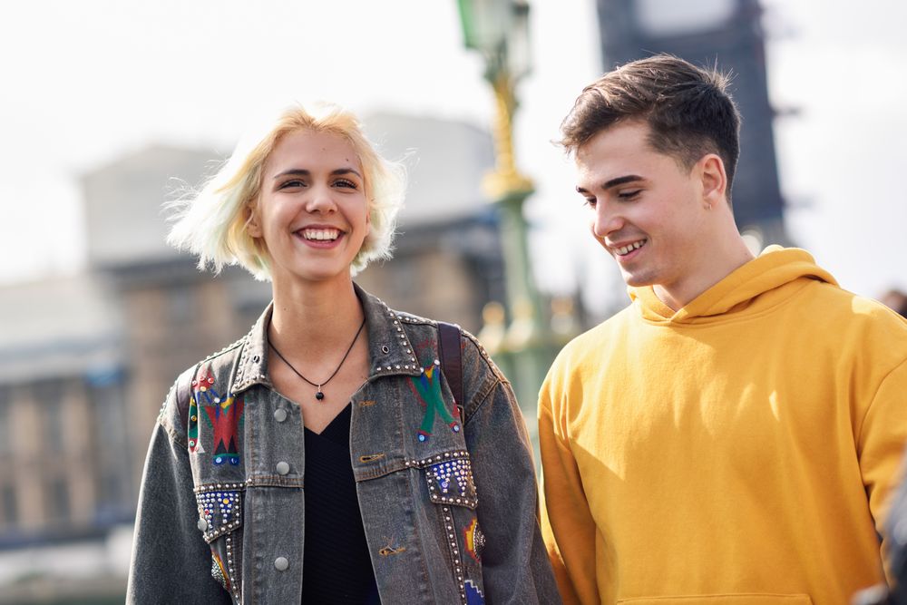 Male and female friend walking on bridge