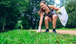 Woman with garbage bag doing plogging