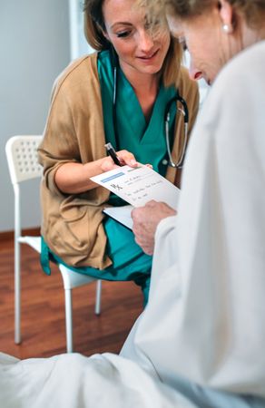 Doctor giving a prescription to patient