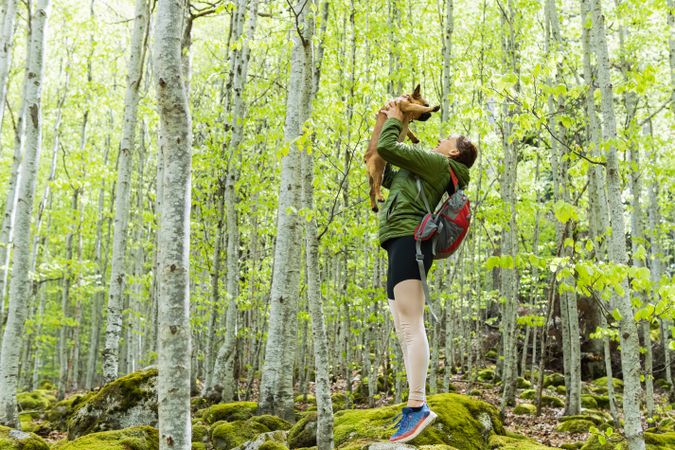 Traveling woman with dog in forest