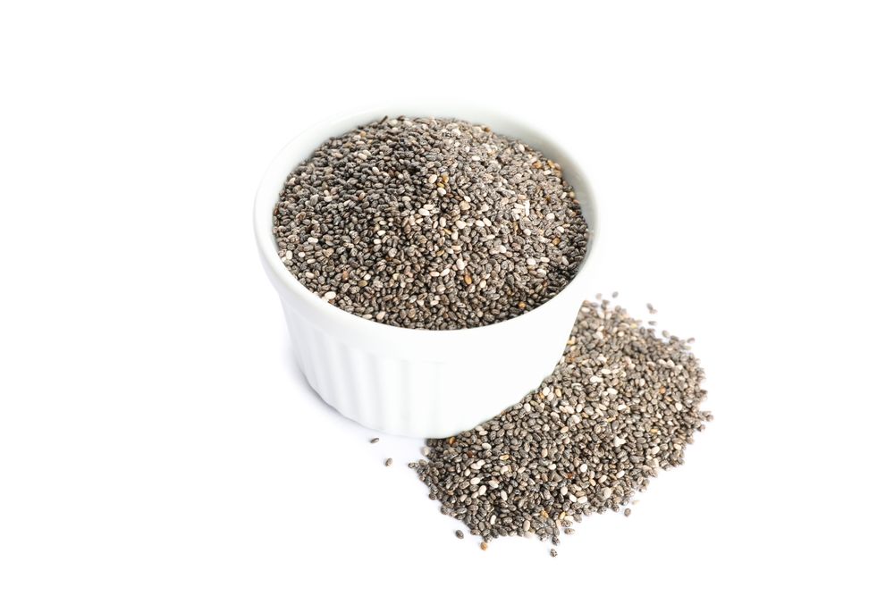 Chia seeds and sauce boat isolated on blank background
