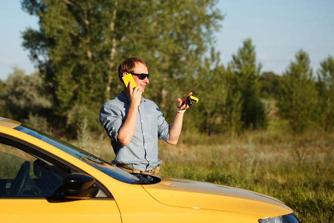 Man talking on his cell phone while holding car keys