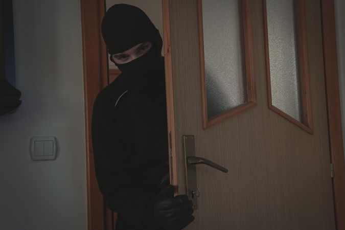 Thief breaking into a house