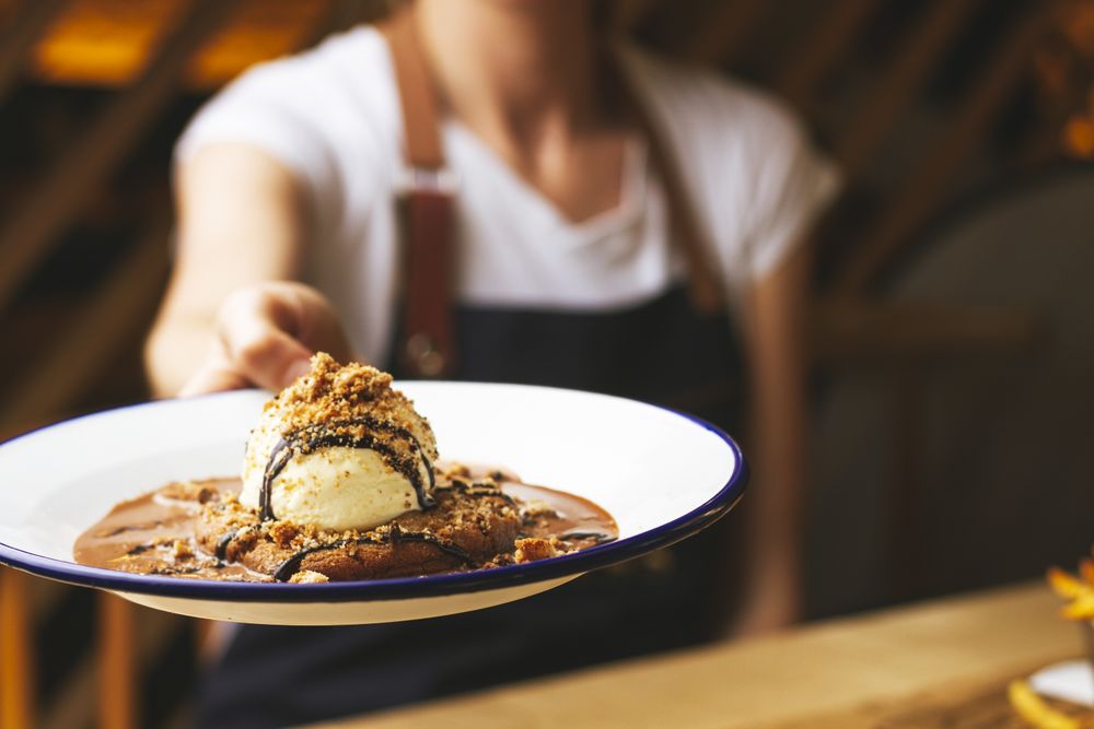 Tasty sweet burger with chocolate crumb and nuts