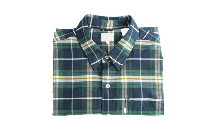 Folded checkered shirt isolated on light background