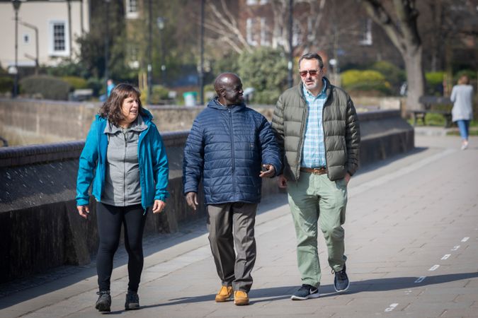 Multi-ethnic group of older adults walking outside