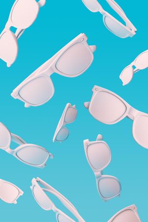 Pattern of sunglasses falling on blue background