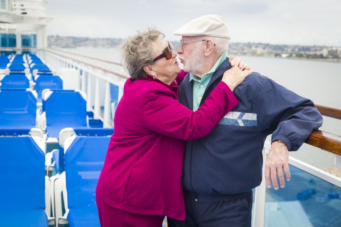 Mature Couple Kissing on Deck of Cruise Ship