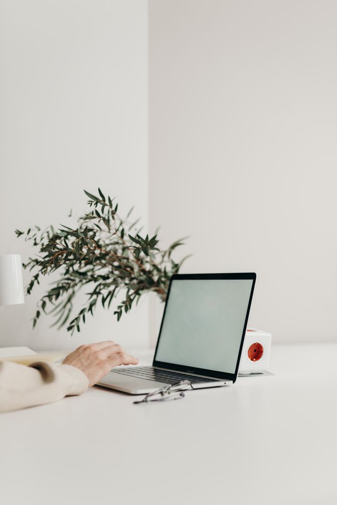 Cropped image of person using laptop on light table