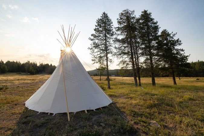 Montana, United States - August 17, 2022: Back of teepee in park with sun flare