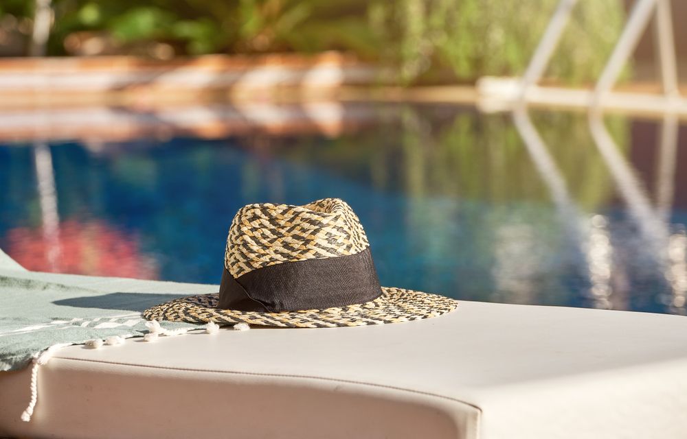 Straw hat with marks near water
