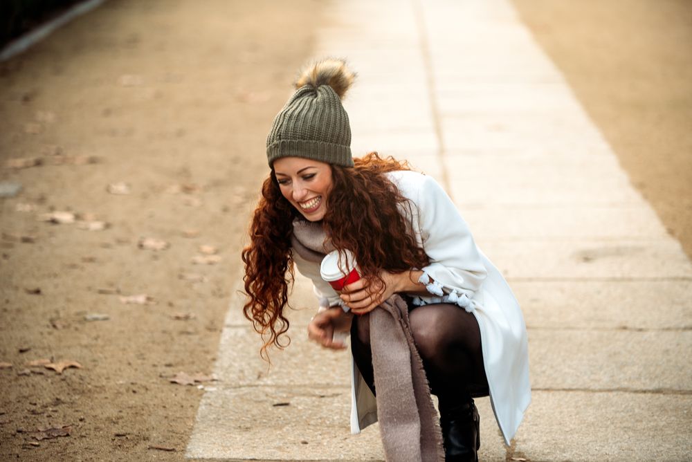 Woman drinking coffee wandering in the streets of Madrid on winter