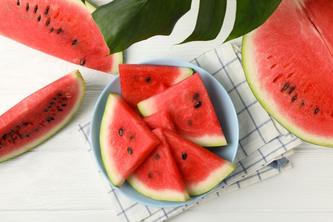 Composition with plate of fresh watermelon on wooden background, top view