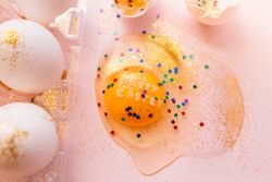 Decorated broken Easter egg on table