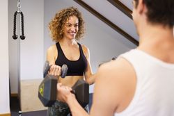 Happy healthy woman working out with partner