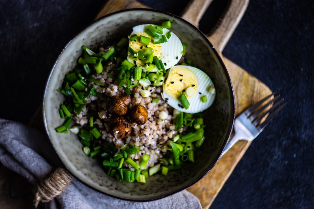 Top view of buckwheat bowl with hard boiled eggs and mushroom