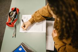 Top view of girl writing on a paper