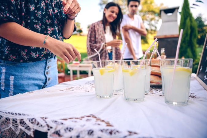 Friends at table with fresh lemonade having fun