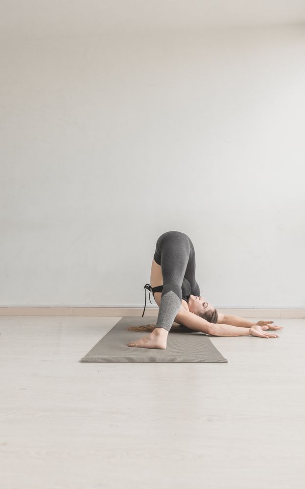 Flexible woman stretching in studio