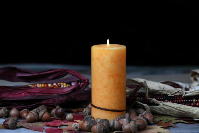 Burning candle for Thanksgiving or Halloween holidays with dark background