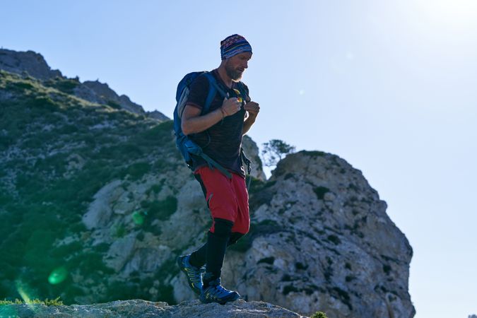Mature man with backpack in mountains